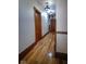 Hallway featuring wooden doors and floors, with overhead lighting and detailed trim at 783 Woodruff Place Middle Dr, Indianapolis, IN 46201