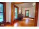 Inviting living room with natural light, gleaming hardwood floors, and original wood trim at 783 Woodruff Place Middle Dr, Indianapolis, IN 46201