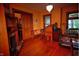 Spacious living room with hardwood floors, ornate fireplace, and vintage decor at 783 Woodruff Place Middle Dr, Indianapolis, IN 46201