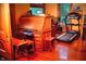 Home office area with roll-top desk, treadmill, wood floors and large windows at 783 Woodruff Place Middle Dr, Indianapolis, IN 46201