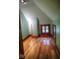 Attic room with angled walls, hardwood floors, and wood trim around the windows at 783 Woodruff Place Middle Dr, Indianapolis, IN 46201