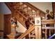 A detailed view of a wooden staircase with decorative balusters and a furry animal head on the end post at 783 Woodruff Place Middle Dr, Indianapolis, IN 46201