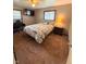 Comfortable bedroom featuring a cozy bed, side table with lamp, and a mounted TV at 8990 N 850 W, Fairland, IN 46126