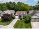 Aerial view of charming home with well-maintained lawn, mature trees, and an attached garage at 9700 River Oak E Ln, Fishers, IN 46038