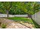 Landscaped backyard featuring a storage shed, manicured lawn, stone pathway, and white fence at 9700 River Oak E Ln, Fishers, IN 46038