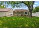 Spacious backyard featuring a well-maintained lawn and privacy fence at 9700 River Oak E Ln, Fishers, IN 46038