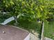 Aerial view of a well-maintained backyard with mature trees, grassy lawn and privacy fence at 9700 River Oak E Ln, Fishers, IN 46038