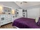 Spacious bedroom with a plush purple bedspread and modern furniture at 9700 River Oak E Ln, Fishers, IN 46038