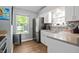 Well-lit kitchen with stainless steel refrigerator and ample counter space at 9700 River Oak E Ln, Fishers, IN 46038