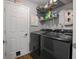 Functional laundry room with modern washer and dryer, storage shelves, and ample space at 9700 River Oak E Ln, Fishers, IN 46038