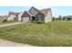 Attractive home featuring a brick facade, attached garage, and a well-manicured lawn at 10112 James Run Dr, Indianapolis, IN 46239