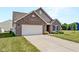 Charming brick home with a two-car garage and a well-maintained front lawn at 10112 James Run Dr, Indianapolis, IN 46239
