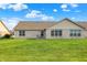 Spacious backyard features lush green grass, patio seating, and a well-kept brick home at 1056 Hilltop Commons Blvd, Whiteland, IN 46184