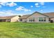 A beautiful backyard with lush green grass, a cozy patio, and well-maintained brick houses at 1056 Hilltop Commons Blvd, Whiteland, IN 46184