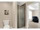 Functional bathroom featuring a toilet and a glass-enclosed shower, leading into a cozy bedroom area at 1056 Hilltop Commons Blvd, Whiteland, IN 46184