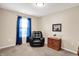 Cozy bedroom showcases a black armchair, side table with flowers, and natural light from the window at 1056 Hilltop Commons Blvd, Whiteland, IN 46184