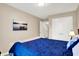 Bedroom with a lake painting, a soft throw blanket on a blue bed, and ample natural light at 1056 Hilltop Commons Blvd, Whiteland, IN 46184