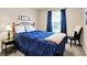 Comfortable bedroom featuring a wrought iron bed frame, soft blue accents, and ample natural light from the window at 1056 Hilltop Commons Blvd, Whiteland, IN 46184