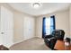 Inviting bedroom exhibits a black armchair, a closet, natural light and neutral walls at 1056 Hilltop Commons Blvd, Whiteland, IN 46184