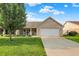 Charming brick home featuring a well-manicured lawn, two-car garage, and inviting front porch at 1056 Hilltop Commons Blvd, Whiteland, IN 46184