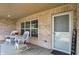 Inviting front porch featuring comfortable wicker seating and front door at 1056 Hilltop Commons Blvd, Whiteland, IN 46184