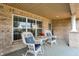 Cozy front porch featuring white wicker rocking chairs and decorative cushions at 1056 Hilltop Commons Blvd, Whiteland, IN 46184