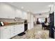 Spacious kitchen with white cabinets and granite counters flowing into the dining area at 1056 Hilltop Commons Blvd, Whiteland, IN 46184