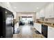 Well-lit kitchen features white cabinets, granite counters and black appliances at 1056 Hilltop Commons Blvd, Whiteland, IN 46184
