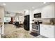 Modern kitchen connects seamlessly to the dining and living spaces at 1056 Hilltop Commons Blvd, Whiteland, IN 46184
