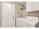 Practical laundry room featuring a washer, dryer, and storage cabinets at 1056 Hilltop Commons Blvd, Whiteland, IN 46184