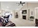 Bright living room featuring a fireplace, ceiling fan and plush carpeting at 1056 Hilltop Commons Blvd, Whiteland, IN 46184