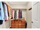 Well-organized walk-in closet with ample hanging space and a charming wooden dresser for storage at 1056 Hilltop Commons Blvd, Whiteland, IN 46184