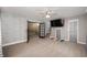 Spacious living room with brick accent wall, and modern ceiling fan at 106 N Jamalee Way, Pendleton, IN 46064