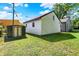 Backyard area features shed and garage with healthy green grass and blue skies at 11 14Th St, Franklin, IN 46131