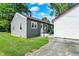 Backyard featuring a grey home, a small concrete porch, and green grass at 11 14Th St, Franklin, IN 46131