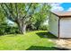 The backyard of the home is lush with mature trees and green grass at 11 14Th St, Franklin, IN 46131