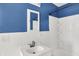 Bathroom with white vanity, sink, and shower with white wainscoting and blue walls at 11 14Th St, Franklin, IN 46131
