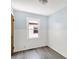 Bedroom featuring light blue walls, wood-look floors, a window, and white wainscoting at 11 14Th St, Franklin, IN 46131