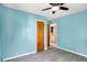 Bright bedroom featuring blue walls, ceiling fan, and wood-look floors at 11 14Th St, Franklin, IN 46131
