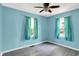 Inviting bedroom with blue walls, complemented by modern ceiling fan, offering style and comfort, filled with natural light at 11 14Th St, Franklin, IN 46131