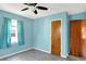 Stylish bedroom with blue walls, modern ceiling fan, and hardwood doors, creating a cozy and welcoming retreat at 11 14Th St, Franklin, IN 46131