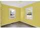 Cozy bedroom featuring yellow walls, wood-look flooring, and natural light at 11 14Th St, Franklin, IN 46131