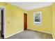 Bright bedroom with yellow walls, wood-look flooring, and a window at 11 14Th St, Franklin, IN 46131