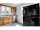 Kitchen with stainless steel dishwasher and black refrigerator, ample natural light, and wood cabinets for organized storage at 11 14Th St, Franklin, IN 46131