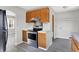 Kitchen with stainless steel stove, wooden cabinets, and updated flooring, combining functionality with essential appliances at 11 14Th St, Franklin, IN 46131