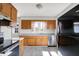 Functional kitchen design with matching wood cabinetry, stainless steel dishwasher, and neutral countertops for a classic look at 11 14Th St, Franklin, IN 46131