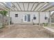 Charming backyard brick patio featuring a pergola with swing seating and lush landscaping at 11105 Deer Valley Dr, Indianapolis, IN 46229