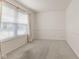 Bright, carpeted bedroom featuring a large window with natural light and neutral décor at 11105 Deer Valley Dr, Indianapolis, IN 46229