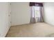 This bedroom features neutral carpeting and a window with gray curtains at 11105 Deer Valley Dr, Indianapolis, IN 46229
