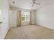 This bedroom features neutral carpeting and a window with white curtains at 11105 Deer Valley Dr, Indianapolis, IN 46229